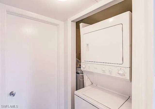 laundry area featuring stacked washing maching and dryer