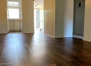 spare room with dark hardwood / wood-style flooring