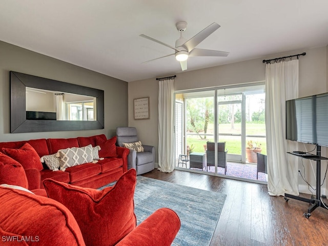 living room featuring ceiling fan and hardwood / wood-style floors