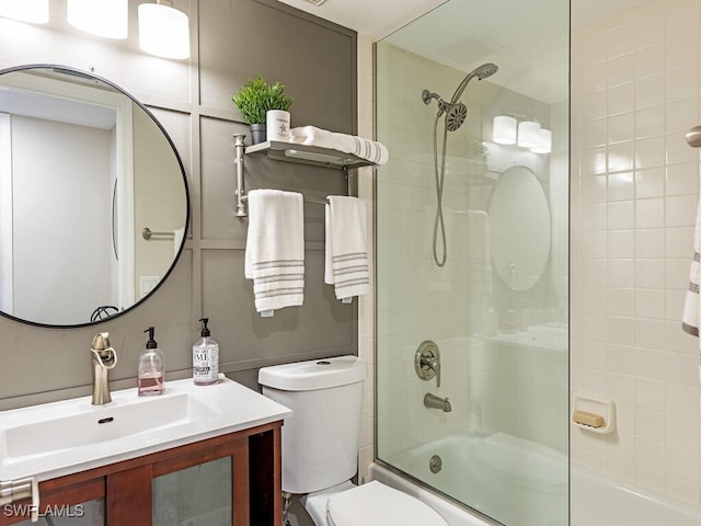 full bathroom with shower / bath combination with glass door, vanity, and toilet