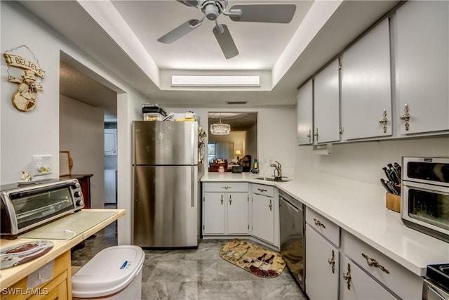 kitchen featuring white cabinets, appliances with stainless steel finishes, ceiling fan, and sink