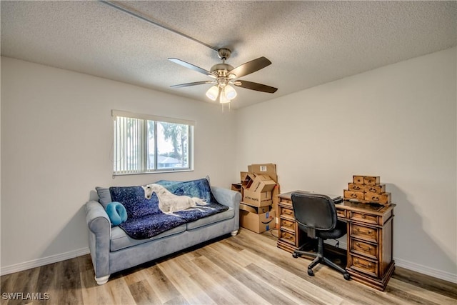 home office featuring ceiling fan, wood-type flooring, and a textured ceiling