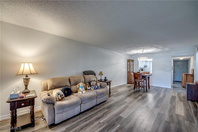 living room with hardwood / wood-style floors and a textured ceiling