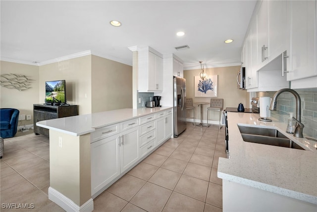 kitchen featuring backsplash, sink, light tile patterned flooring, white cabinetry, and stainless steel appliances