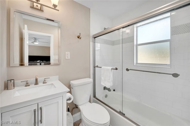 full bathroom featuring toilet, vanity, and combined bath / shower with glass door