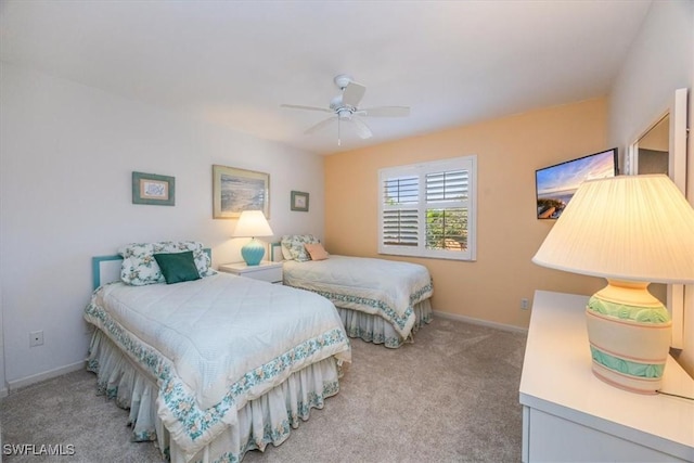 carpeted bedroom featuring a ceiling fan and baseboards