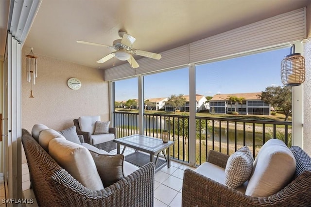 sunroom featuring ceiling fan and a residential view