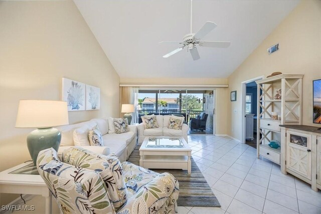 living room with high vaulted ceiling, ceiling fan, and light tile patterned floors