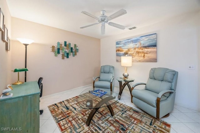 sitting room with visible vents, ceiling fan, baseboards, and light tile patterned floors