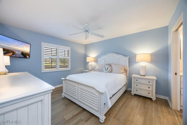 bedroom featuring a ceiling fan, baseboards, and light wood finished floors