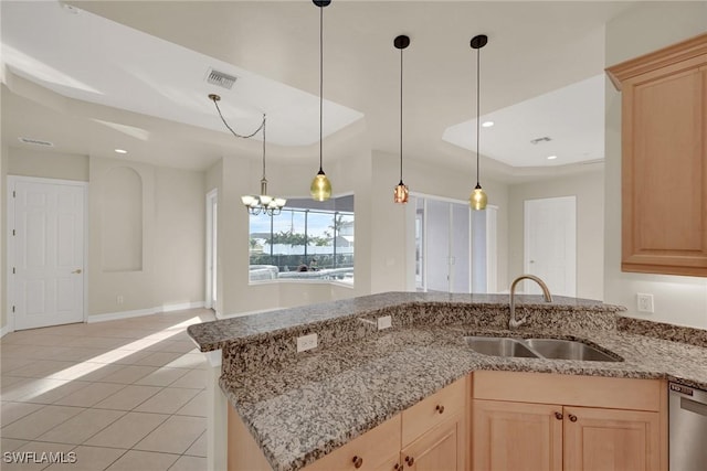 kitchen with light tile patterned floors, light brown cabinets, a notable chandelier, stainless steel dishwasher, and sink