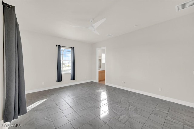 tiled spare room with ceiling fan