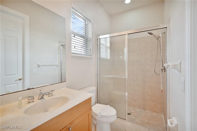 bathroom featuring vanity, toilet, tile patterned flooring, and a shower with door