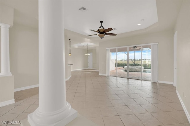 tiled spare room featuring ceiling fan and ornate columns