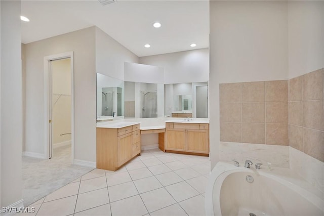 bathroom featuring vanity, tile patterned flooring, and shower with separate bathtub