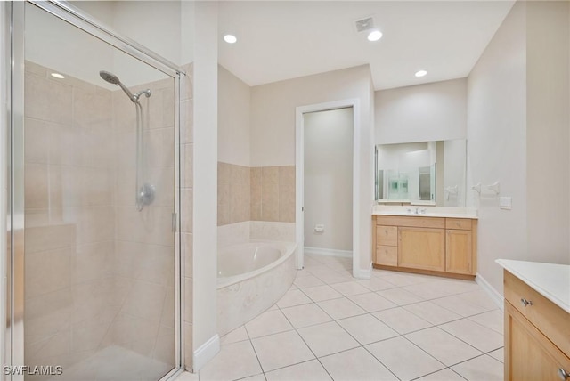 bathroom featuring tile patterned floors, vanity, and shower with separate bathtub