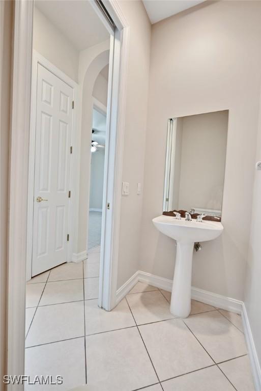 bathroom featuring ceiling fan and tile patterned floors