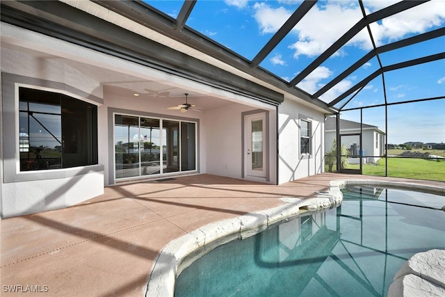 view of pool with ceiling fan, a lanai, and a patio area