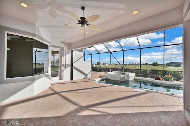 view of pool featuring ceiling fan, a patio area, and glass enclosure