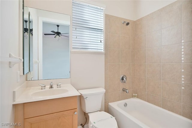 full bathroom with ceiling fan, vanity, toilet, tiled shower / bath, and plenty of natural light