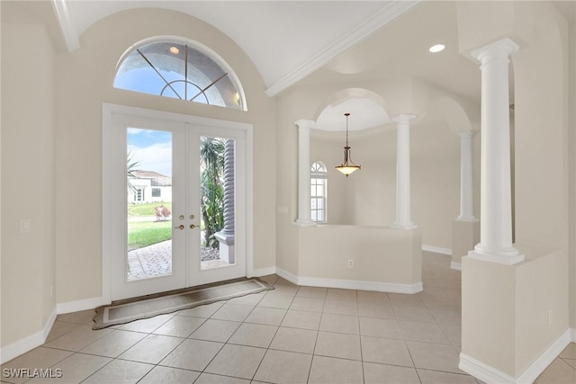 tiled entrance foyer with lofted ceiling, french doors, and ornamental molding