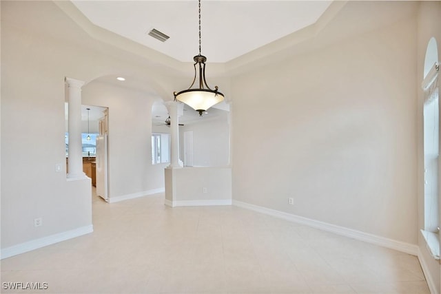 empty room with ceiling fan and decorative columns