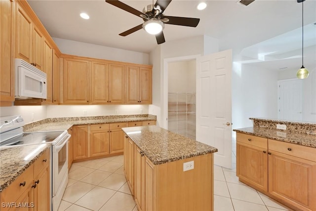 kitchen featuring decorative light fixtures, light stone counters, white appliances, and a kitchen island