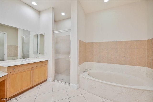 bathroom featuring independent shower and bath, tile patterned floors, and vanity