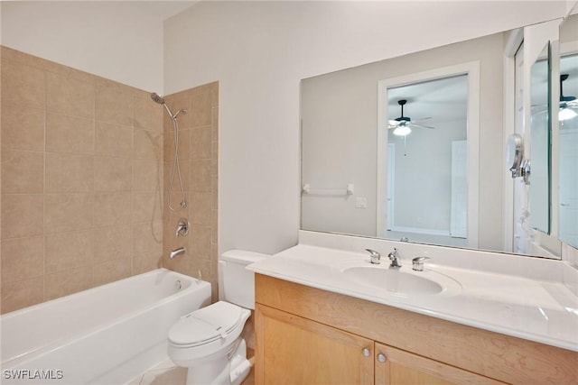 full bathroom featuring toilet, ceiling fan, tiled shower / bath, and vanity