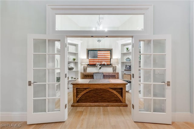 interior space featuring a chandelier and light hardwood / wood-style flooring