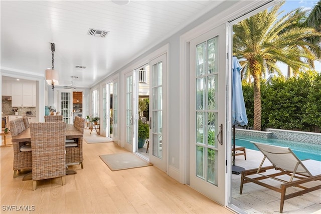 doorway to outside featuring french doors and light wood-type flooring