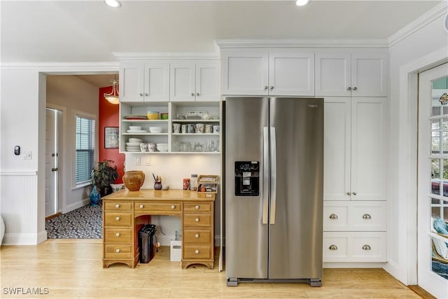 interior space with crown molding, a healthy amount of sunlight, and light wood-type flooring