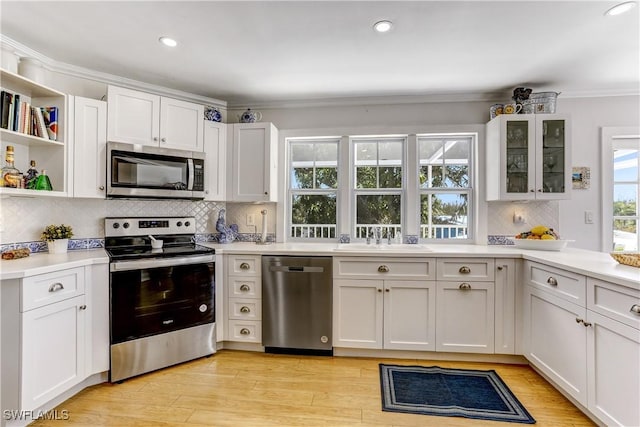 kitchen with sink, white cabinets, and appliances with stainless steel finishes