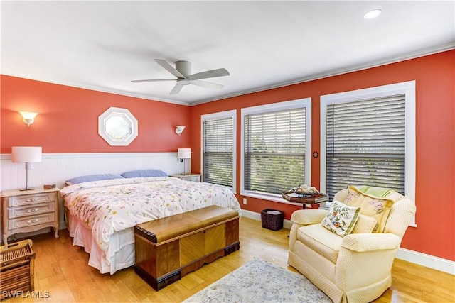 bedroom featuring ceiling fan, light hardwood / wood-style floors, and crown molding