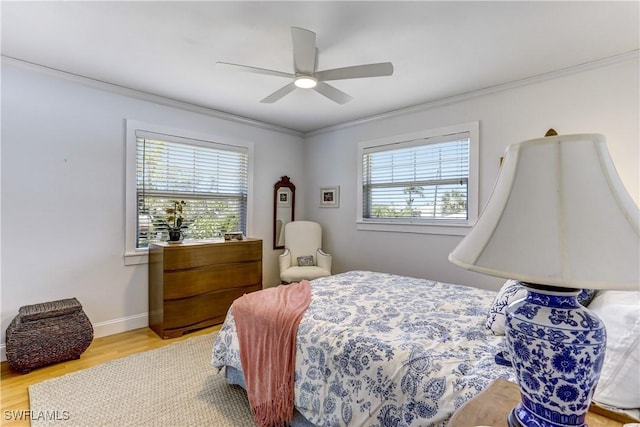 bedroom with multiple windows, ceiling fan, and ornamental molding