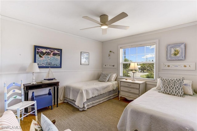 bedroom featuring hardwood / wood-style floors, ceiling fan, and crown molding