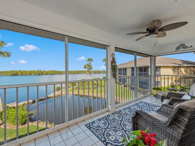 sunroom with a water view, plenty of natural light, and ceiling fan