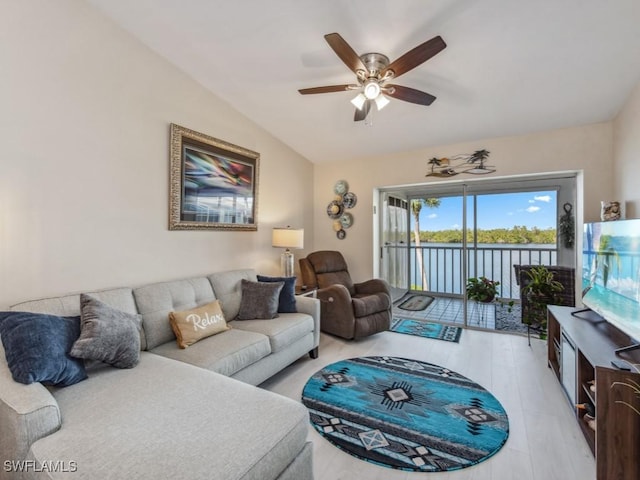 living room featuring light hardwood / wood-style flooring, ceiling fan, and lofted ceiling