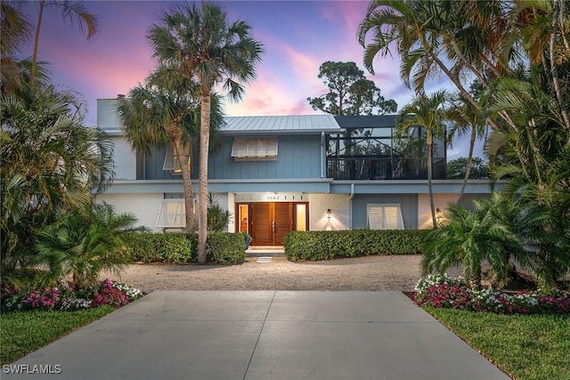 view of front of home featuring glass enclosure