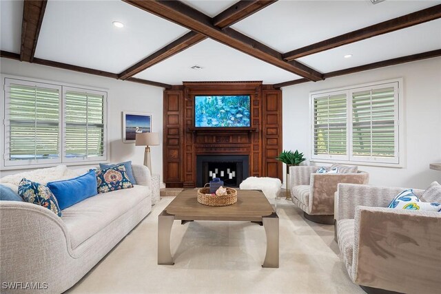 living area featuring beam ceiling, recessed lighting, and a large fireplace