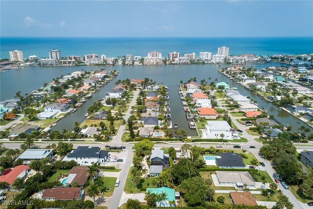 drone / aerial view featuring a city view and a water view