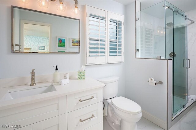 bathroom featuring vanity, toilet, baseboards, and a stall shower