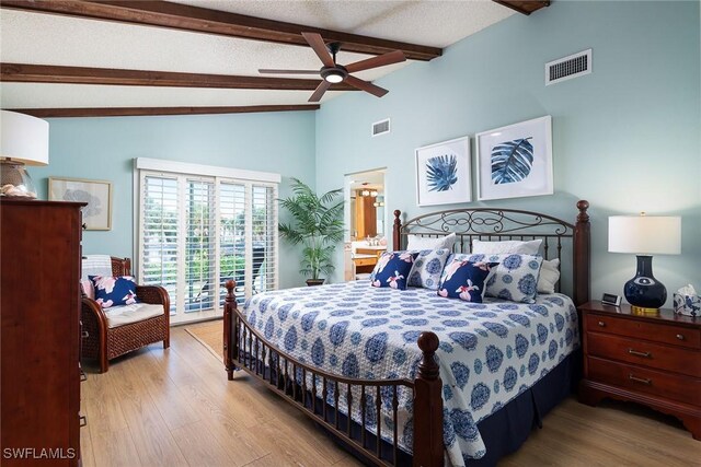 bedroom with access to exterior, visible vents, lofted ceiling with beams, and wood finished floors