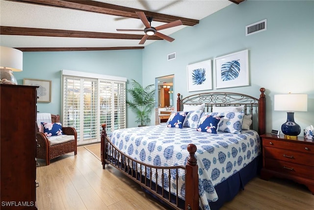 bedroom featuring access to exterior, visible vents, lofted ceiling with beams, and wood finished floors