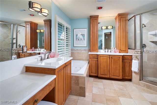 bathroom with visible vents, a shower stall, a tub with jets, and a sink