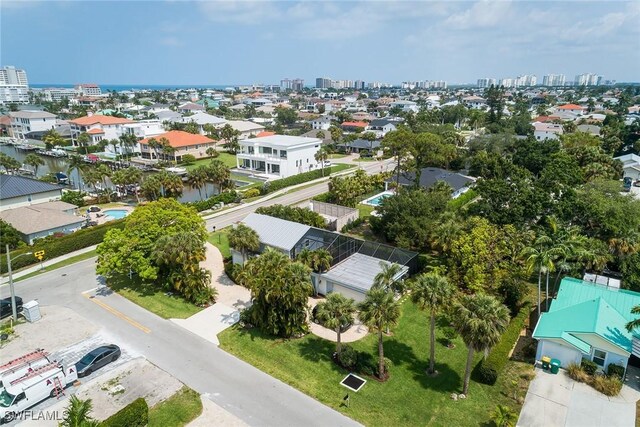 drone / aerial view featuring a city view and a water view