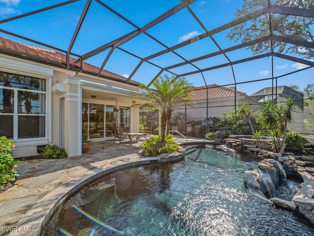 view of swimming pool with a patio, pool water feature, and glass enclosure