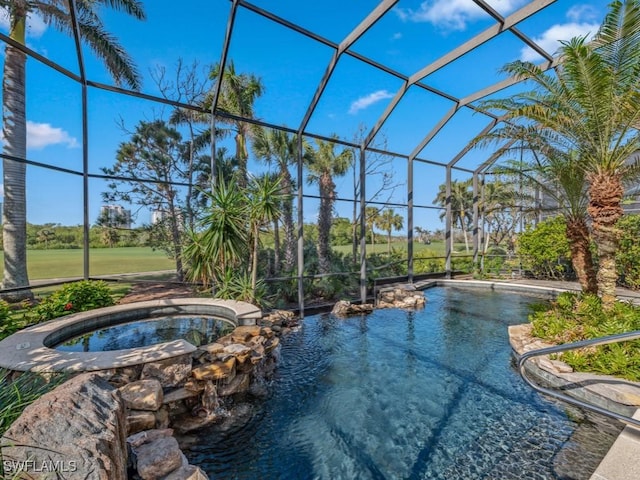 view of swimming pool featuring a lanai and an in ground hot tub