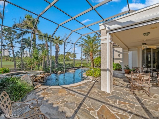 view of swimming pool featuring ceiling fan, a patio area, an in ground hot tub, and glass enclosure