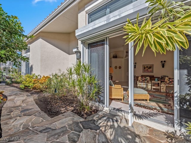 property entrance featuring a patio